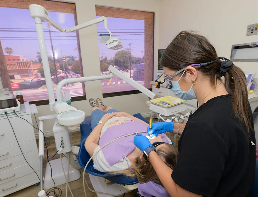 A dentist at Woodland Hills Family Dentistry caring for a patient